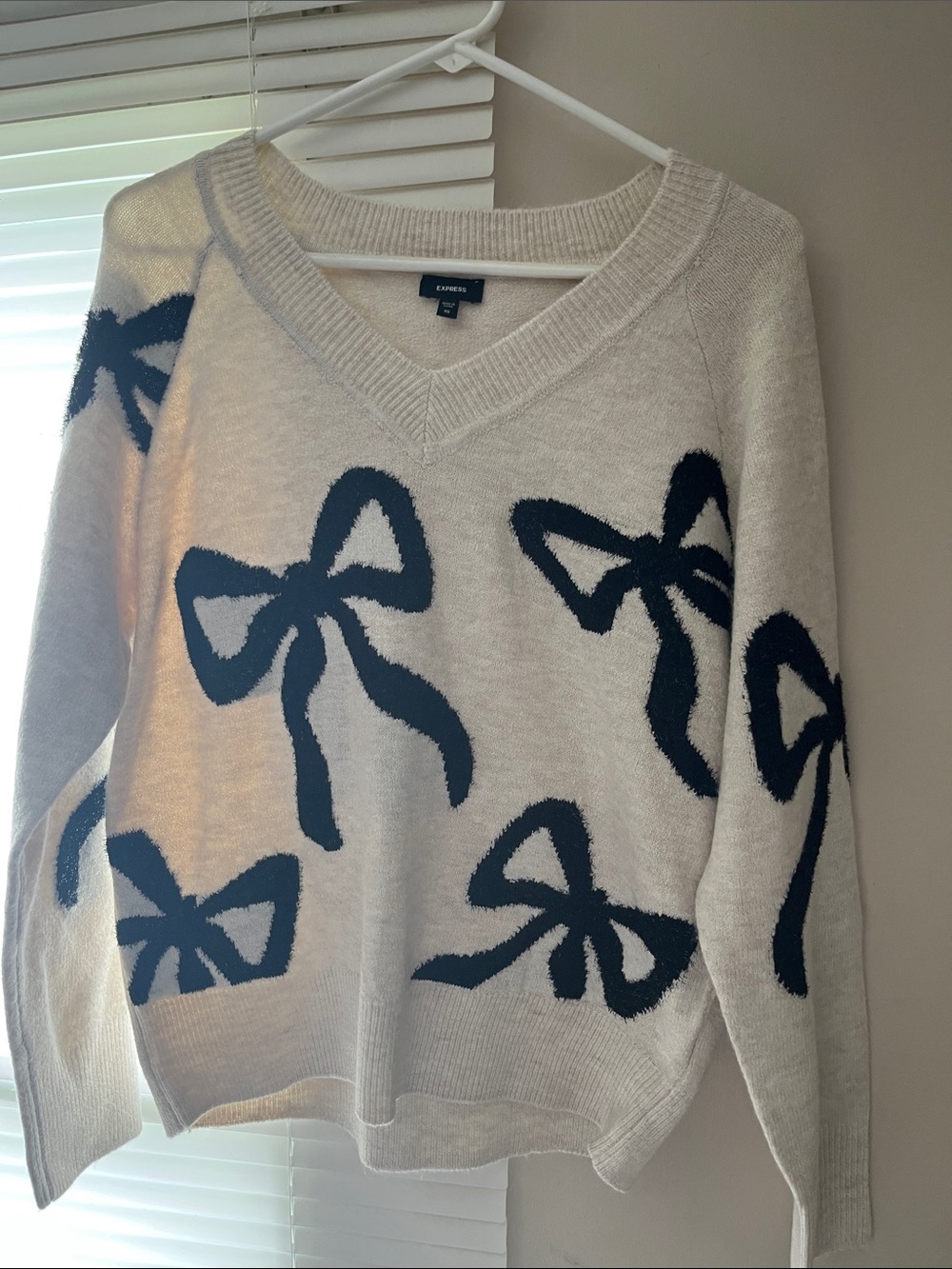 Express Cream V-Neck Sweater with Navy Bow Motif